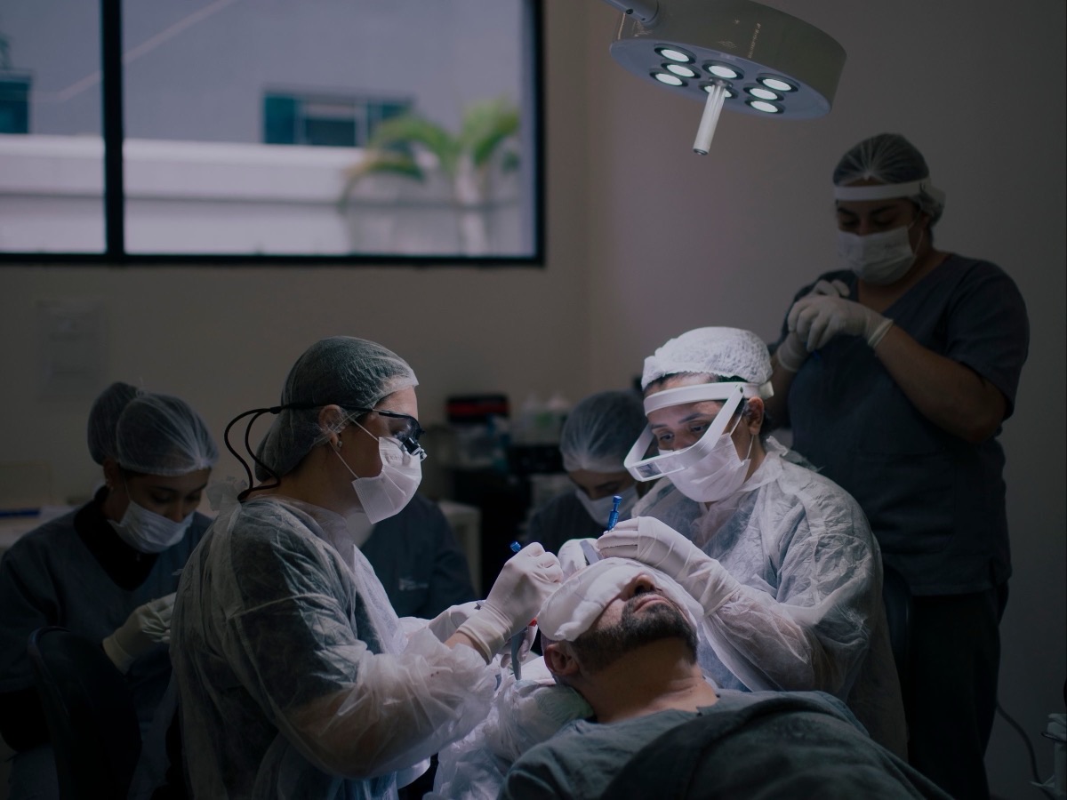 A hair transplant team at work in an operating room